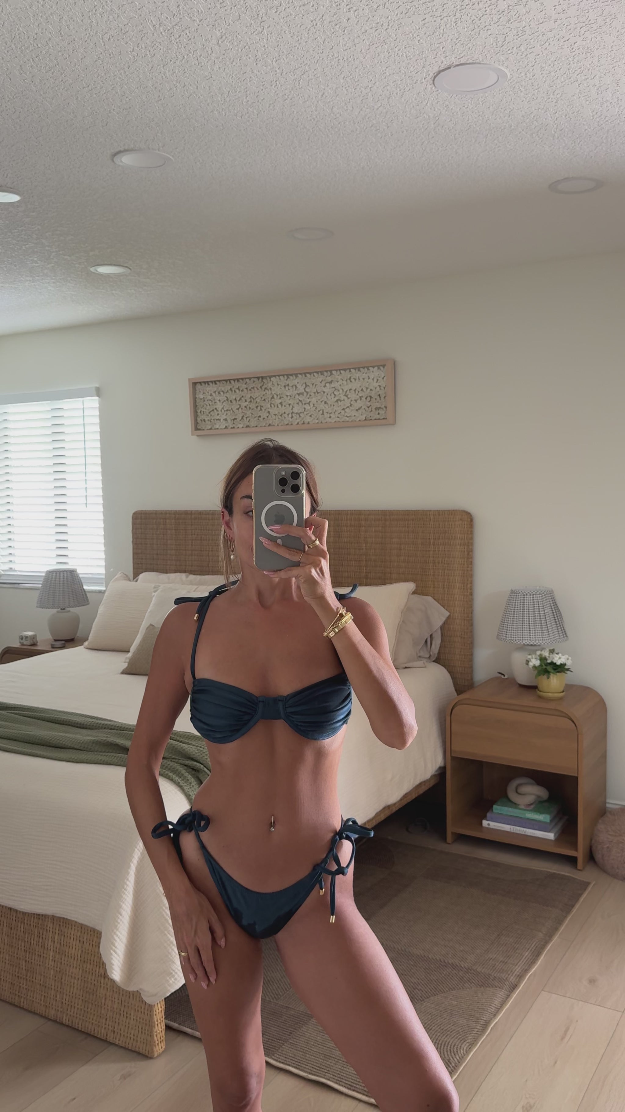 woman wearing luxury soft satin navy two-piece swimsuit bikini set